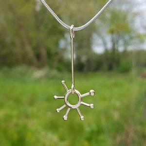 Sunburst pendant, silver snake chain